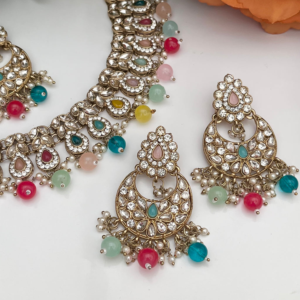 Elegant Multicoloured with gold base necklace with tikka and earrings.