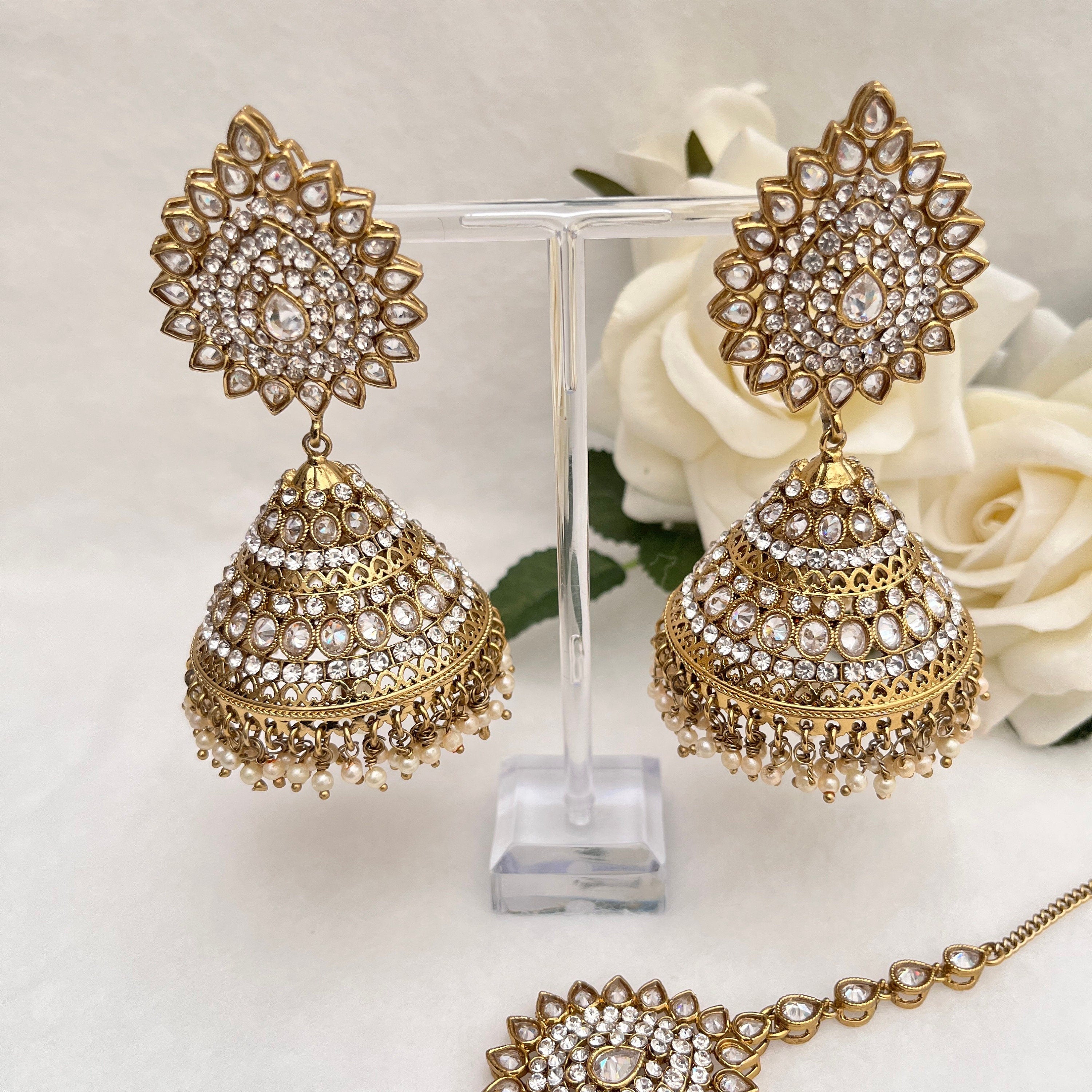 Indian Jewellery with heavy earrings and tikka, Gold in colour with Polki stones