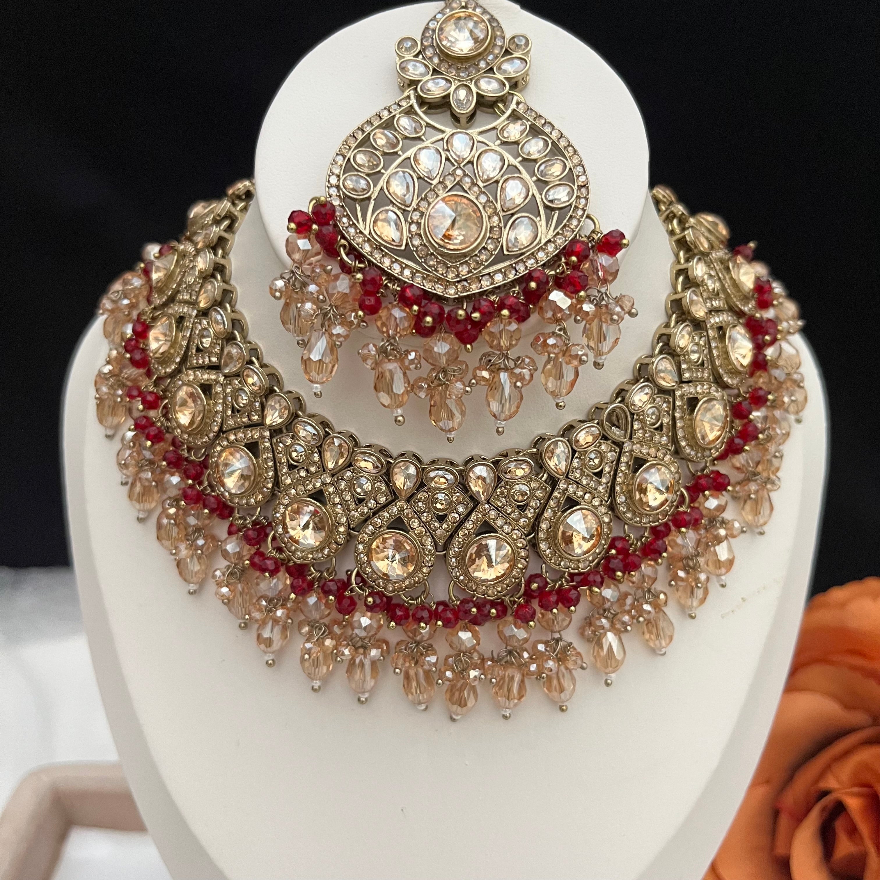 Gold and burgundy Polki diamonds necklace set.