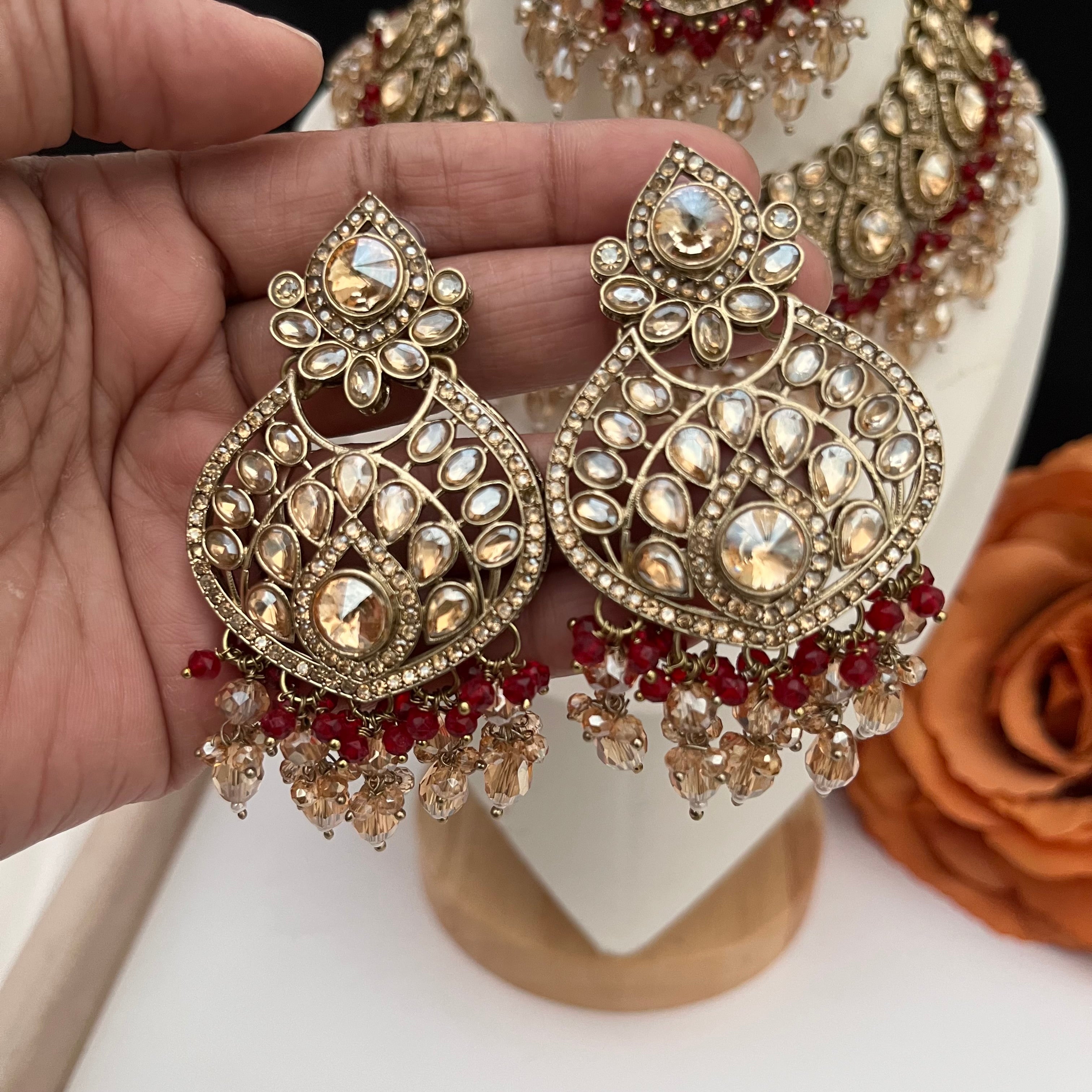 Gold and burgundy Polki diamonds necklace set.