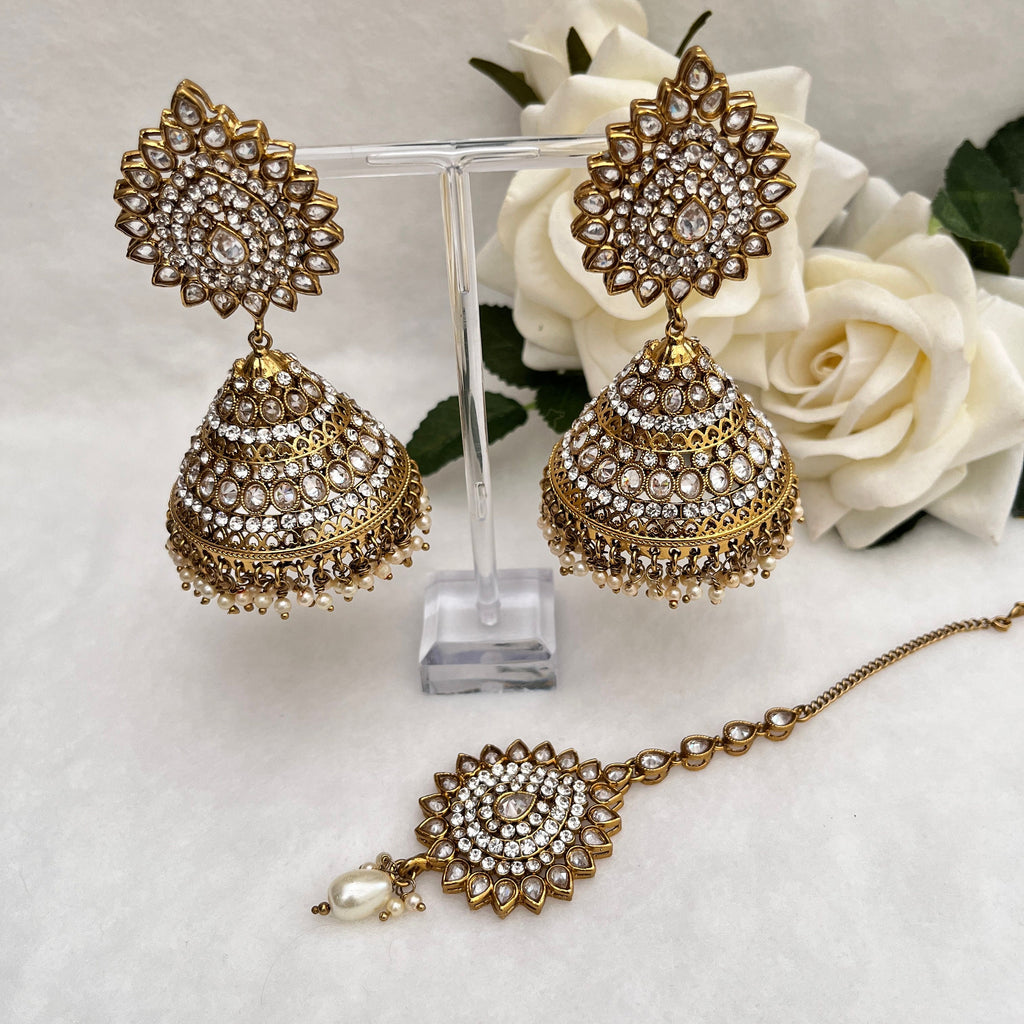 Indian Jewellery with heavy earrings and tikka, Gold in colour with Polki stones