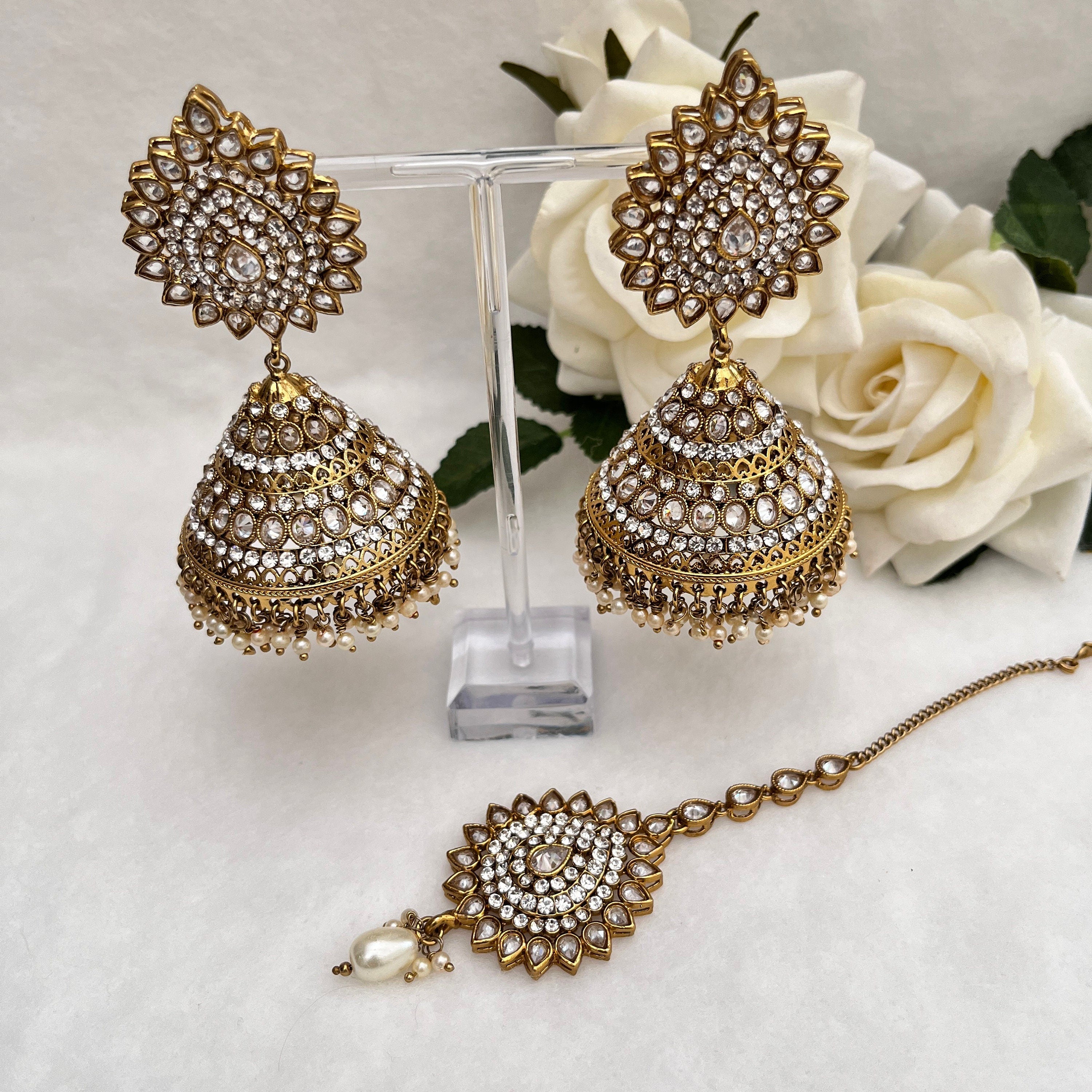 Indian Jewellery with heavy earrings and tikka, Gold in colour with Polki stones