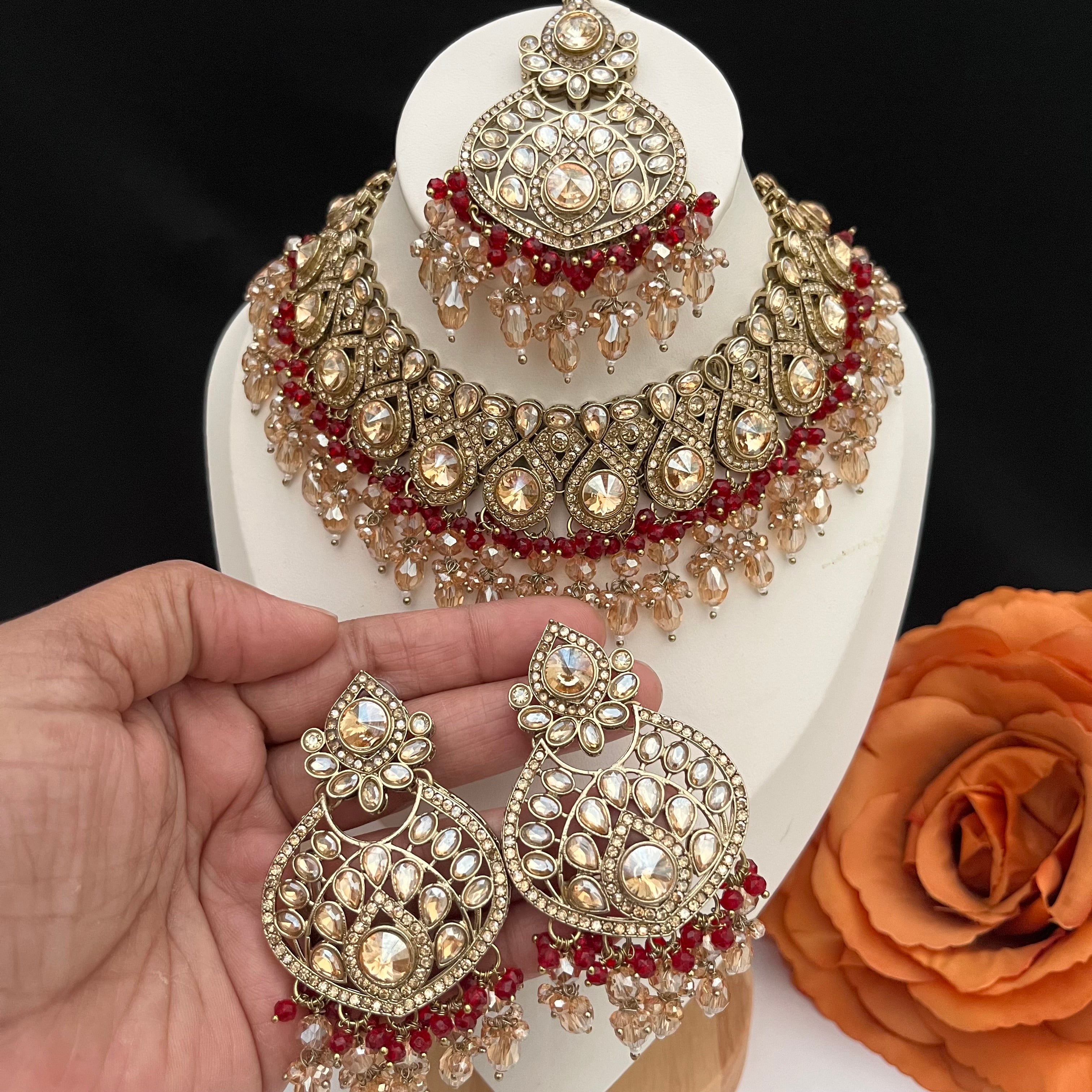 Gold and burgundy Polki diamonds necklace set.