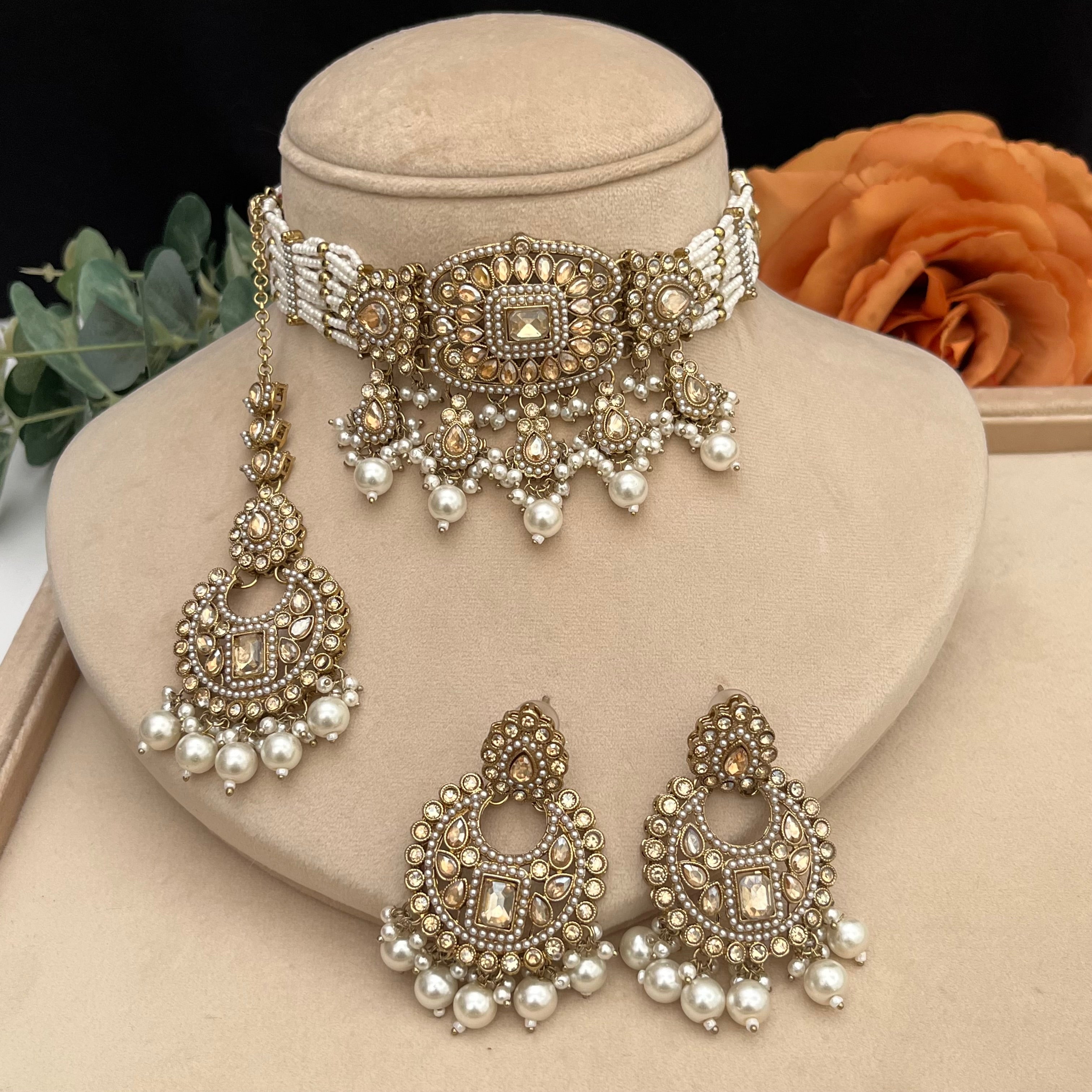 Elegant antique gold with brown Polki stones Choker with white pearls.