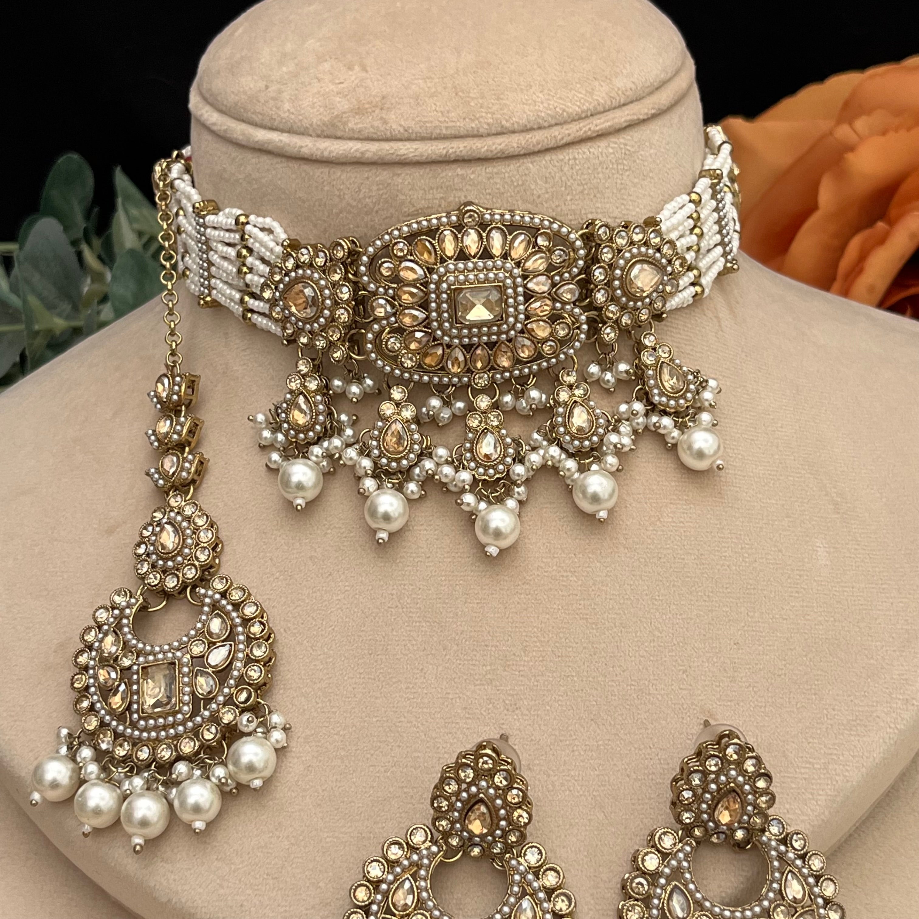 Elegant antique gold with brown Polki stones Choker with white pearls.