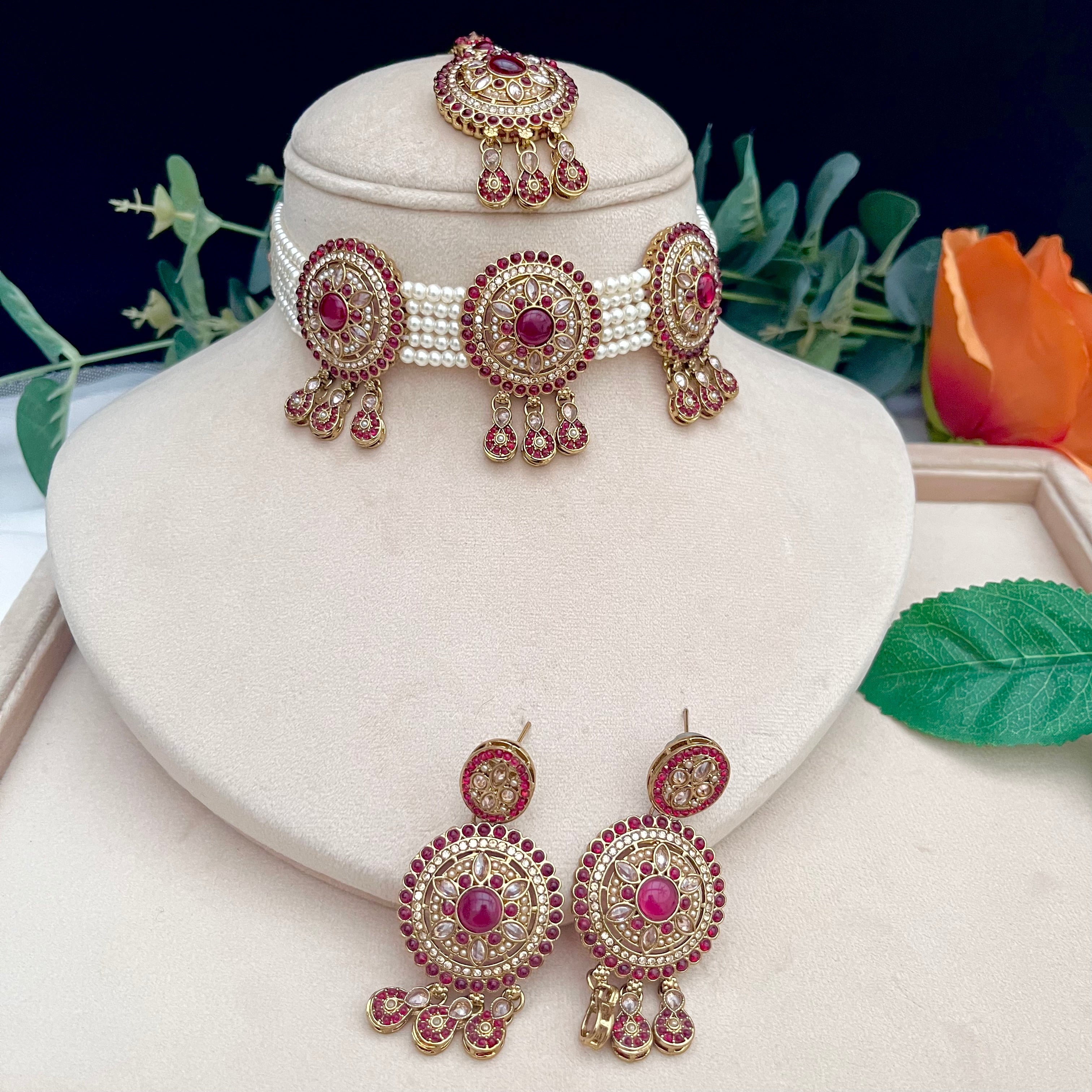 White pearl choker with tikka and earrings, gold with pink stones