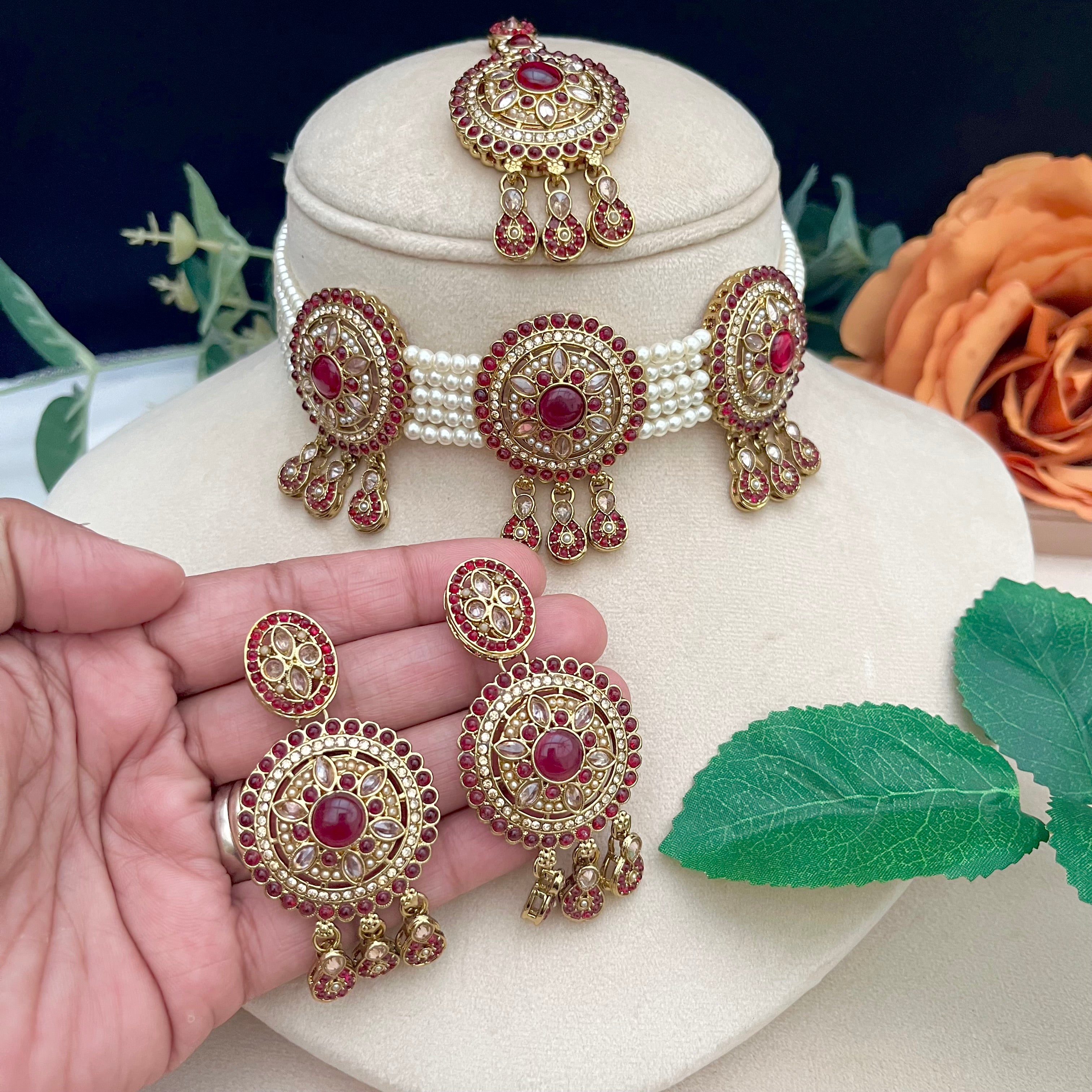 White pearl choker with tikka and earrings, gold with pink stones