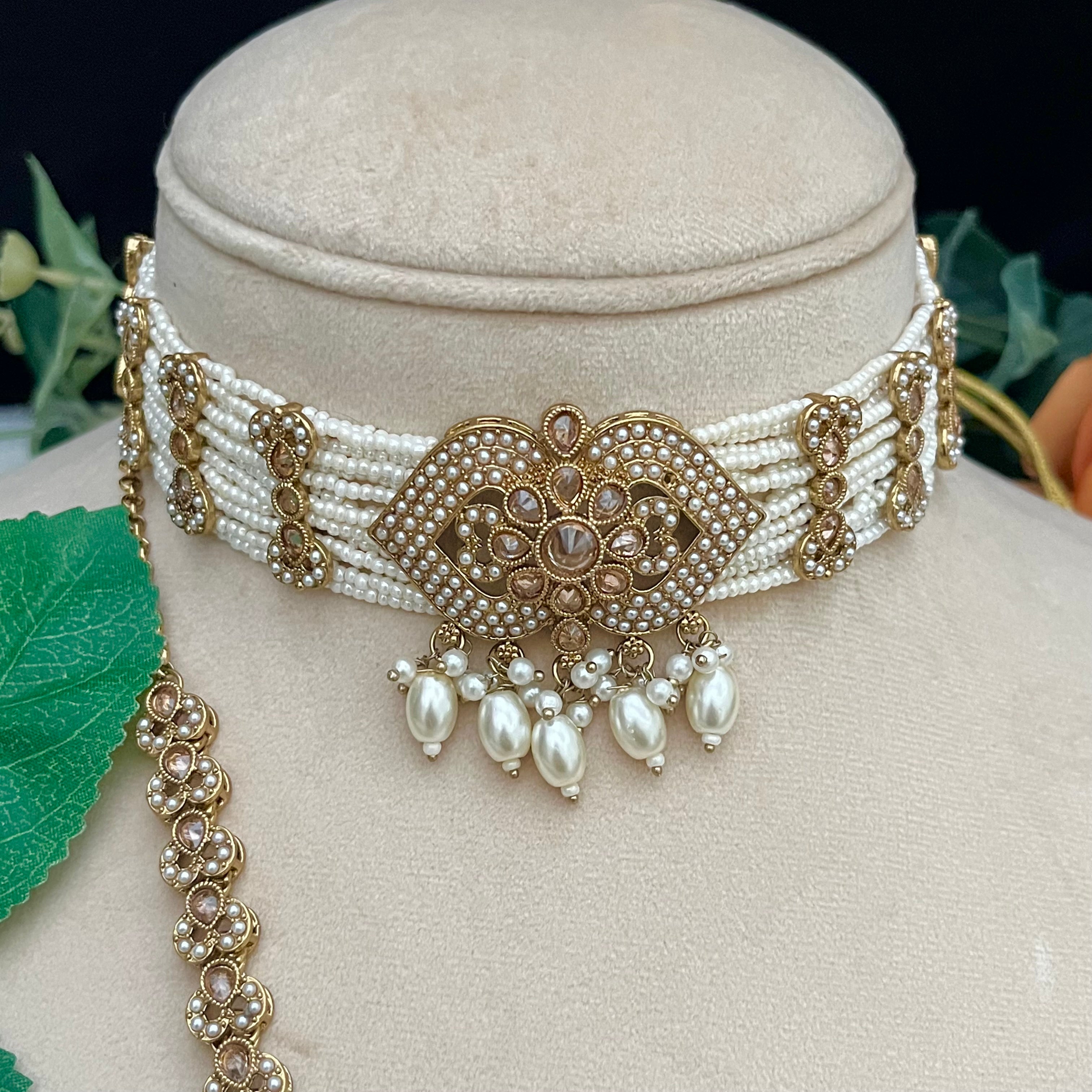 Beaded White pearl choker with Polki stones and pearls.