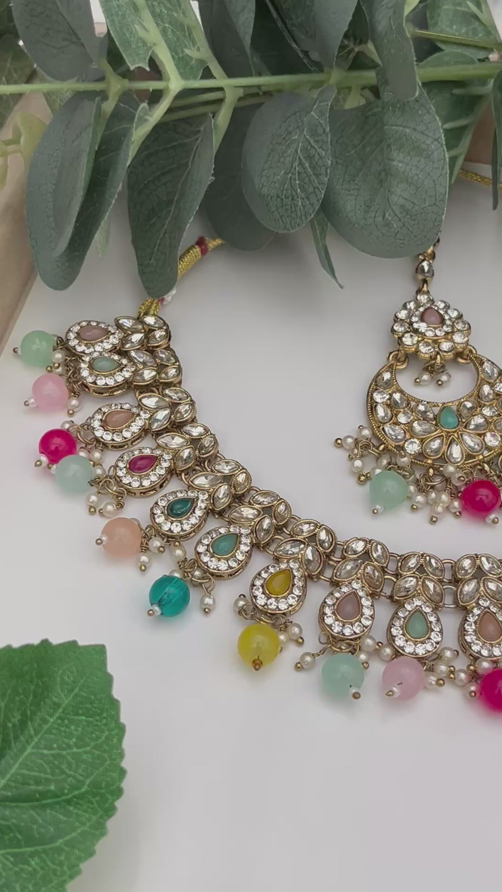 Elegant Multicoloured with gold base necklace with tikka and earrings.
