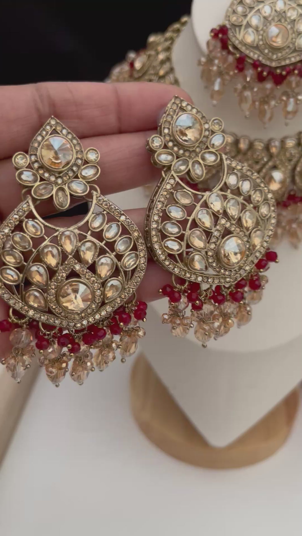 Gold and burgundy Polki diamonds necklace set.